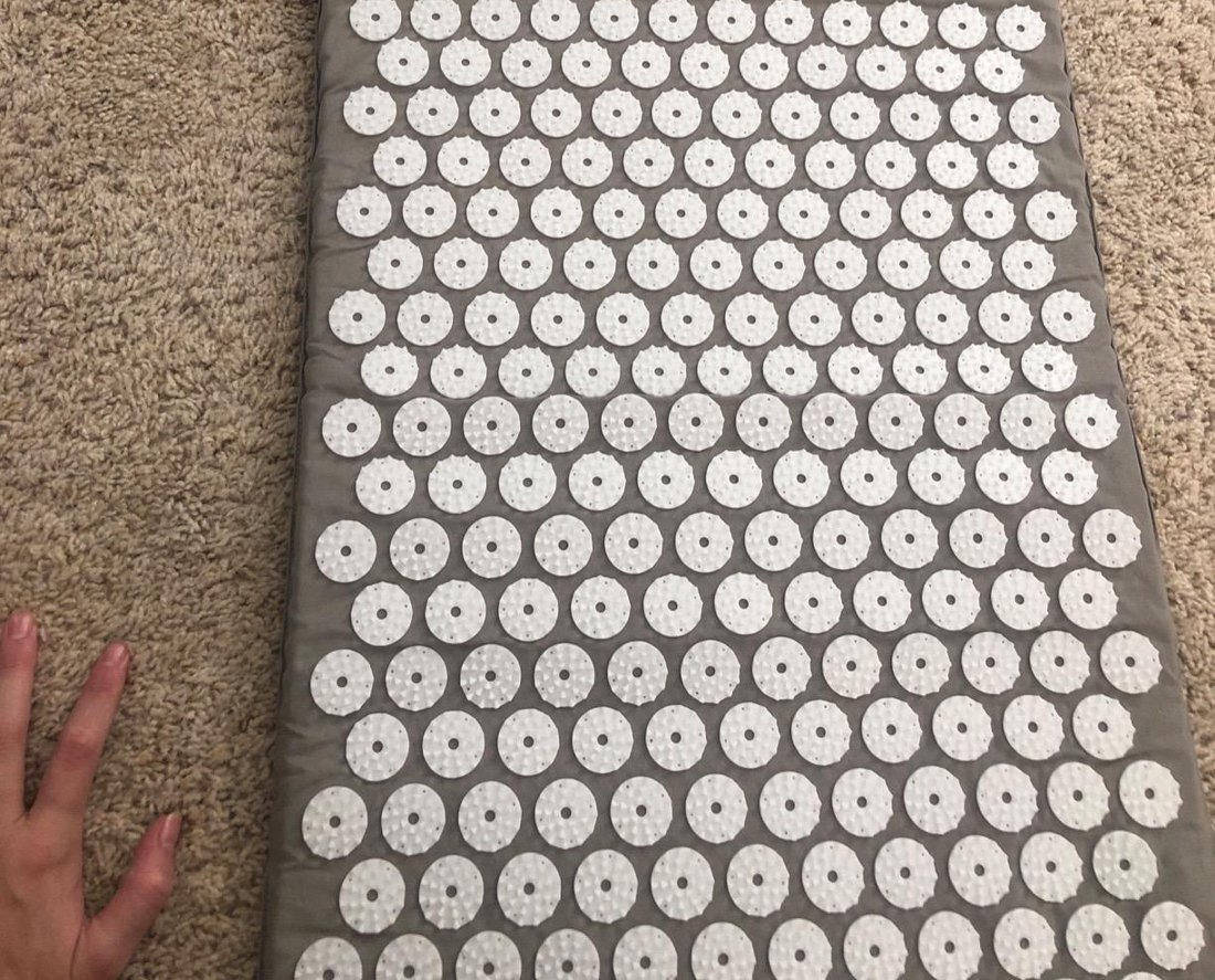 Customer photo of the grey acupressure mat laid out on carpet